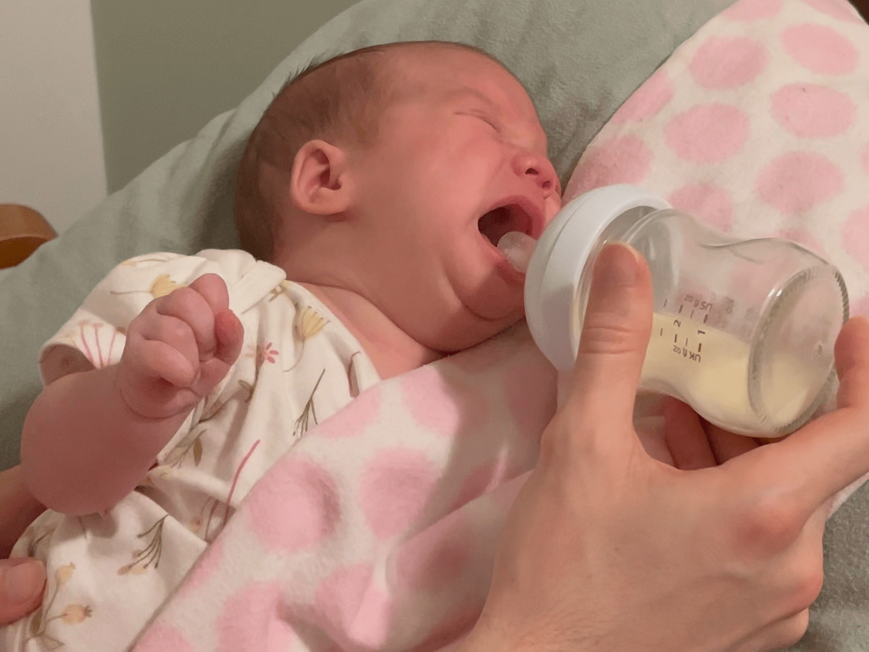 Newborn baby crying when offered a bottle